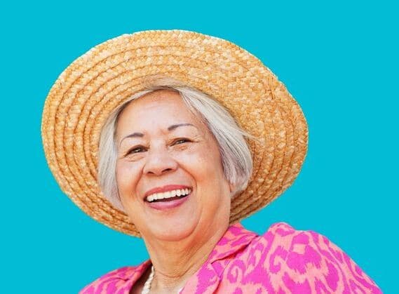 A mature woman smiling after she got the RxSight® Light Adjustable Lens™ procedure done after cataract surgery