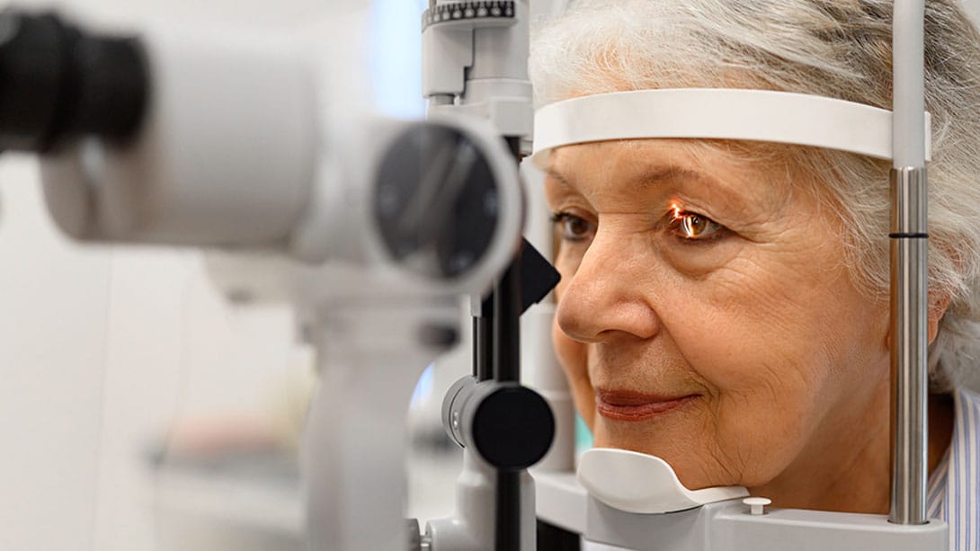 older woman getting an eye exam for lasik in Orlando, FL